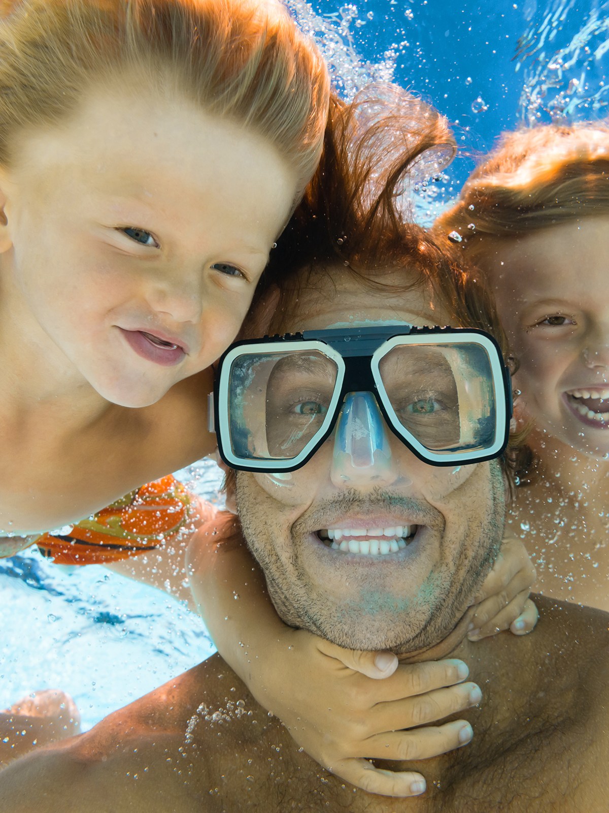 Dad and sons fun underwater selfie while snorkeling in Key Largo