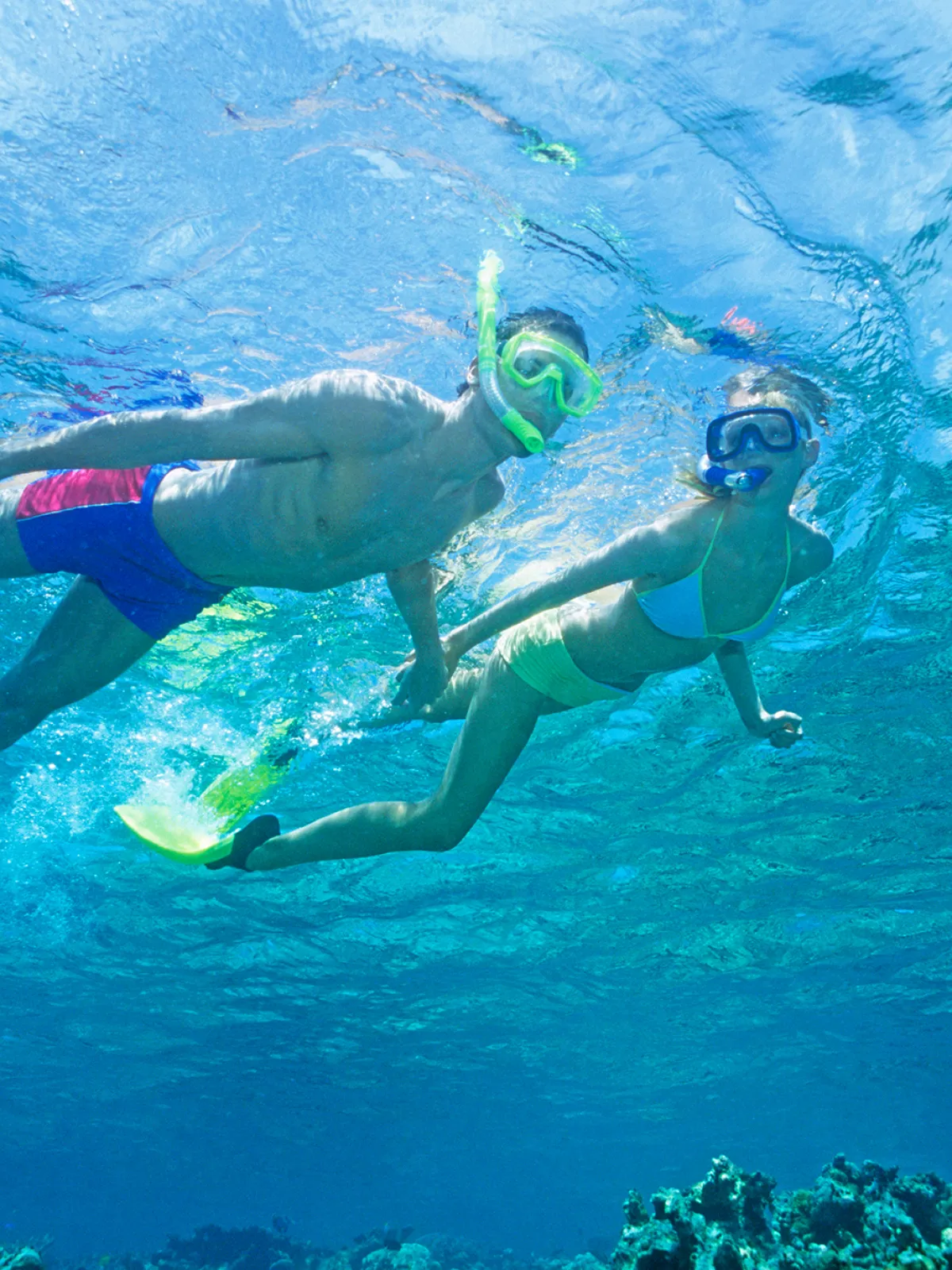 Young couple snorkeling above coral reef in Key Largo