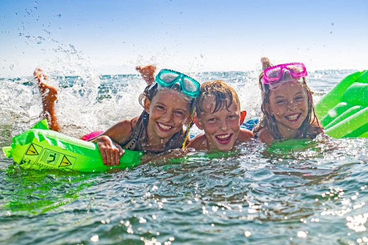 Kids snorkeling and swimming at shallow coral reefs in Key Largo